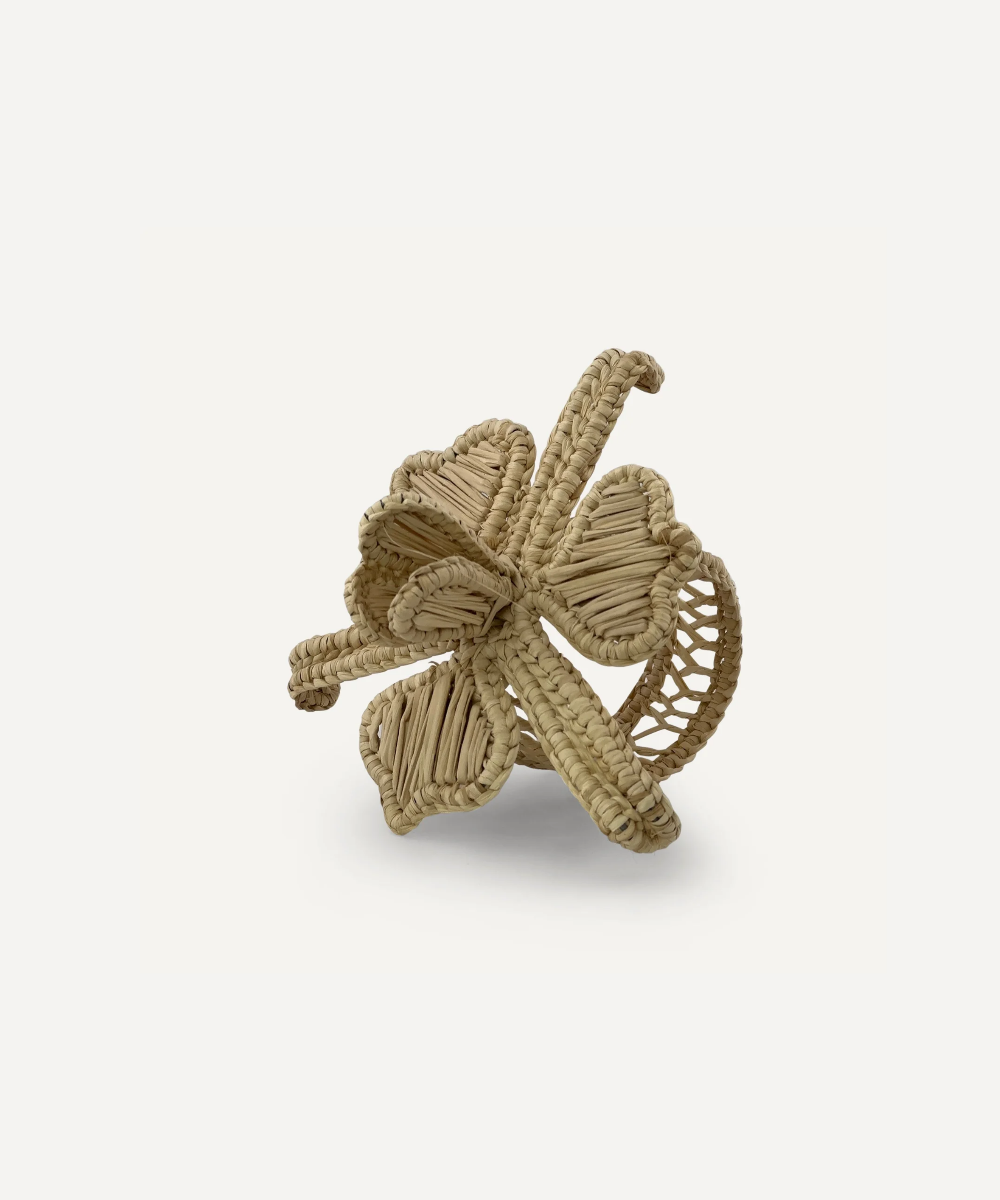 Textured napkin ring with a flower design on a light beige background