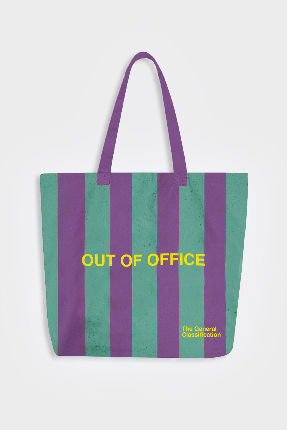 A canvas tote bag with vertical purple and teal-green stripes, featuring the yellow text 'OUT OF OFFICE' across the center and 'The General Classification' in the bottom right corner, set against a light gray background.