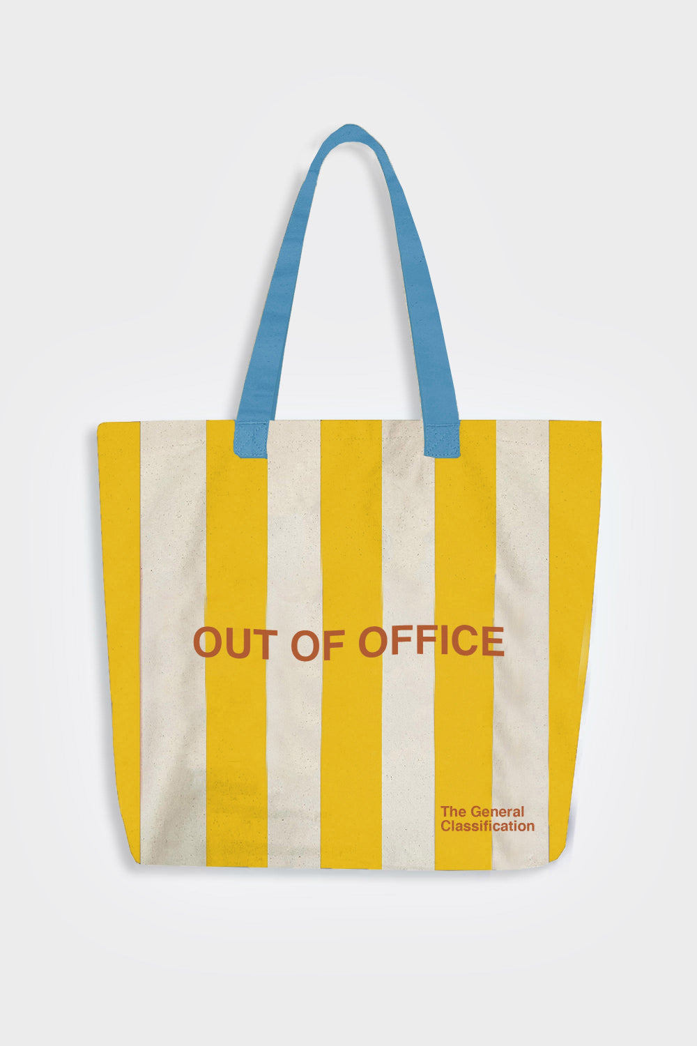 A canvas tote bag with vertical yellow and off-white stripes, featuring blue shoulder straps and the words 'OUT OF OFFICE' printed in muted red across the center, with 'The General Classification' in small text near the bottom right.