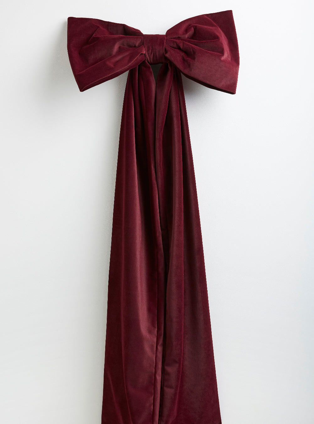 Close-up detail of the handmade oversized burgundy velvet Christmas bow