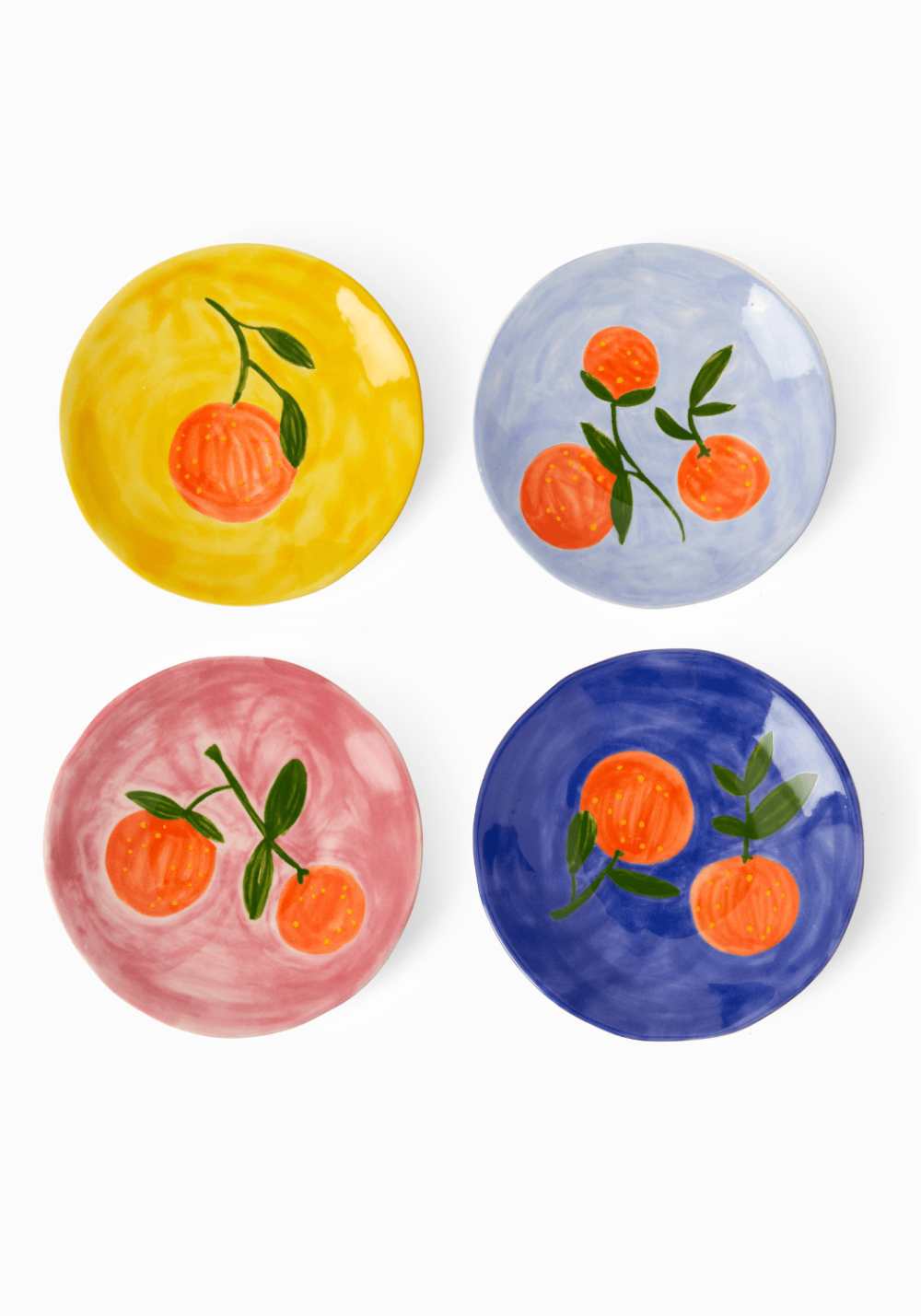 Four colourful plates with orange illustrations on a white background