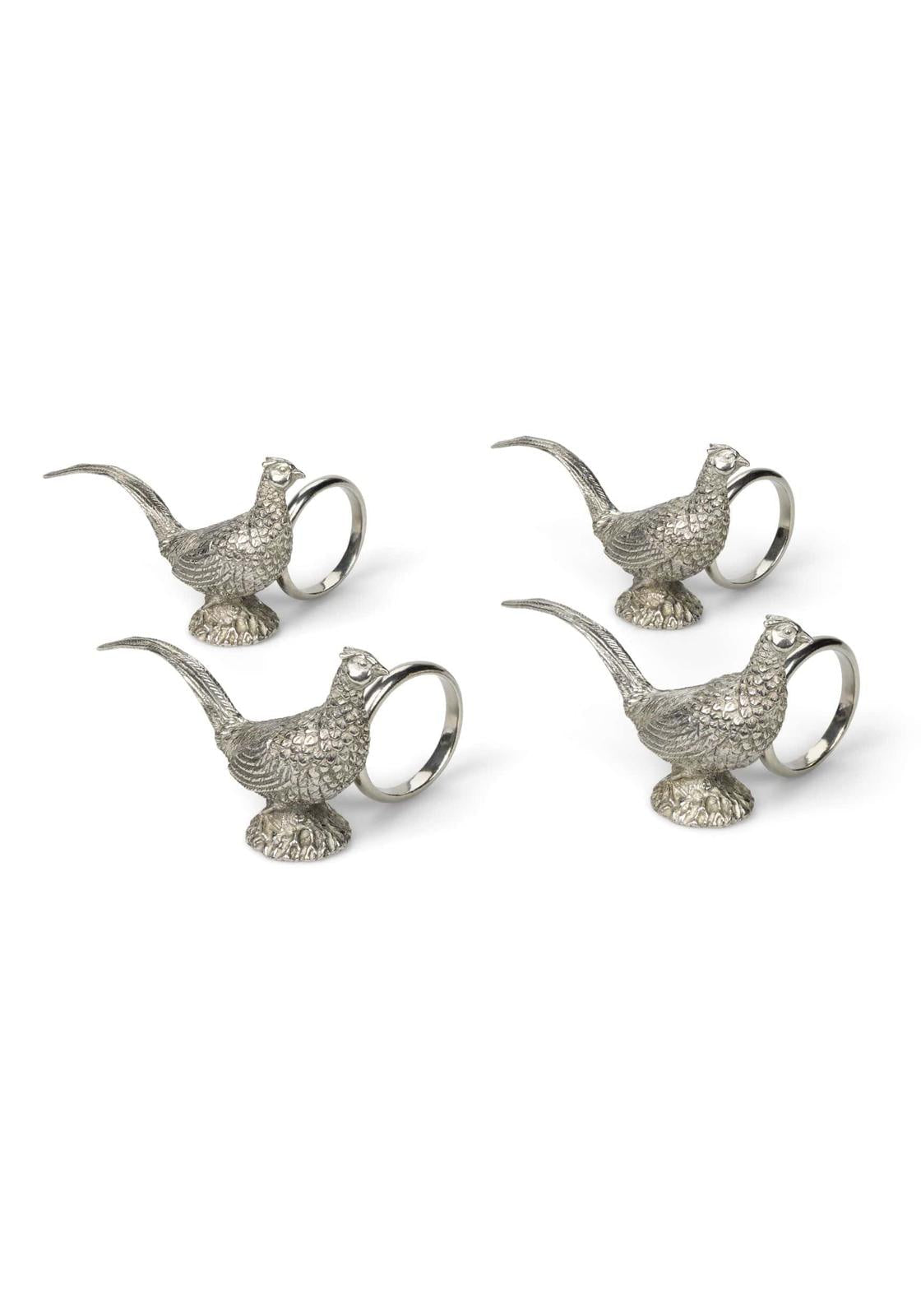 Set of four pewter pheasant bird-shaped napkin rings on a white background