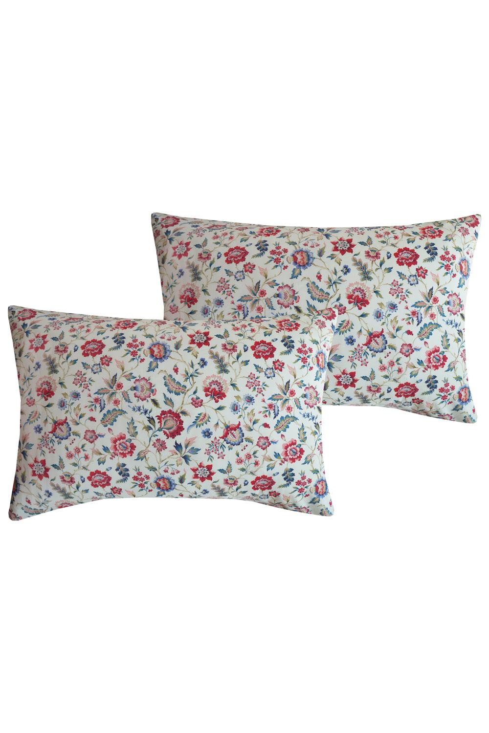 Two floral-patterned pillows on a white background