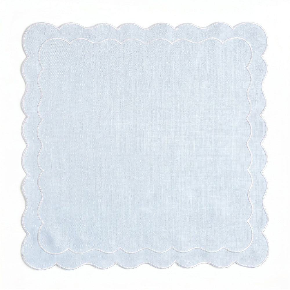 Powder blue scalloped napkin on a white background