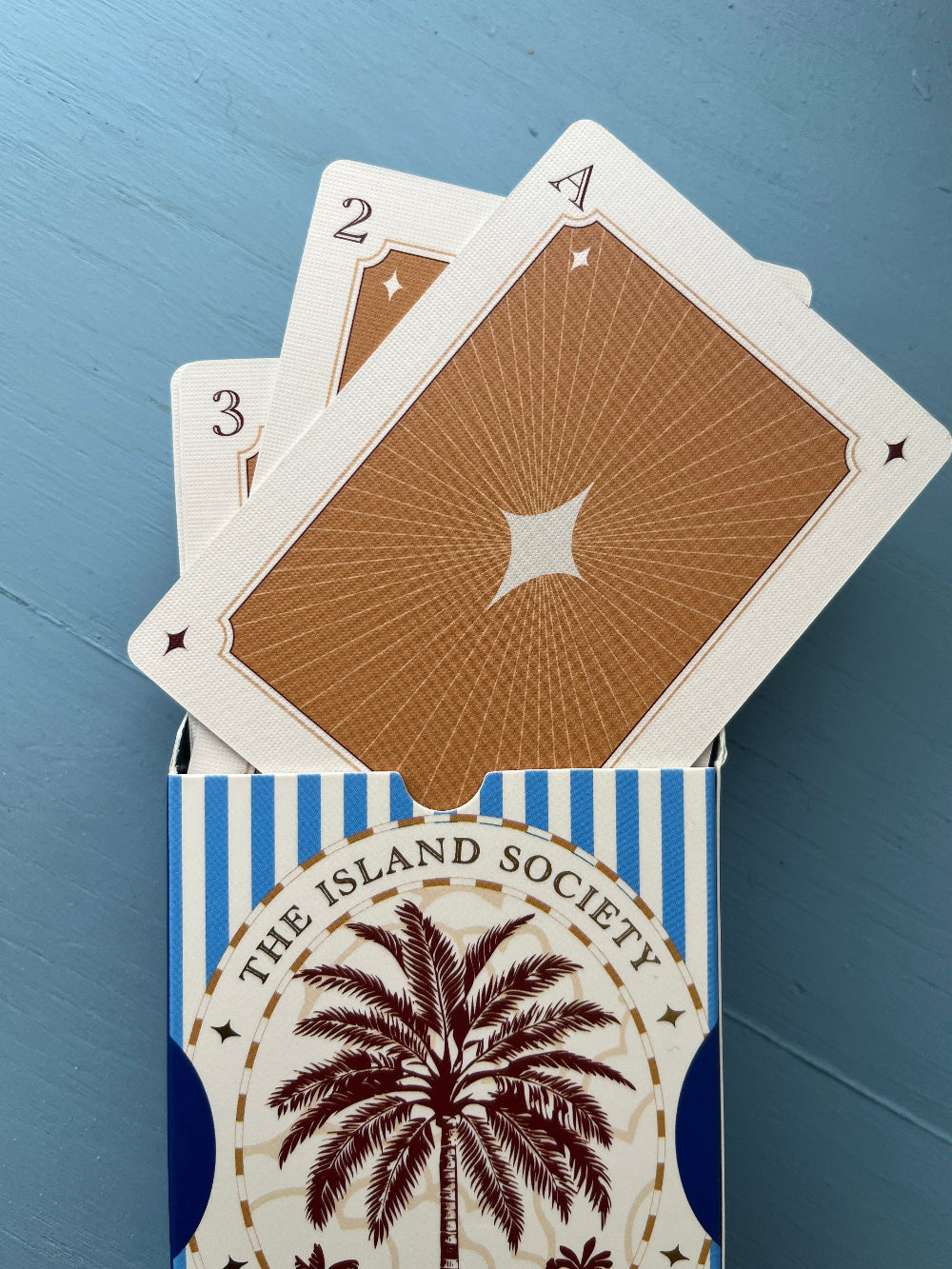 Premium blue illustrated playing cards with a linen-finish cardstock design.