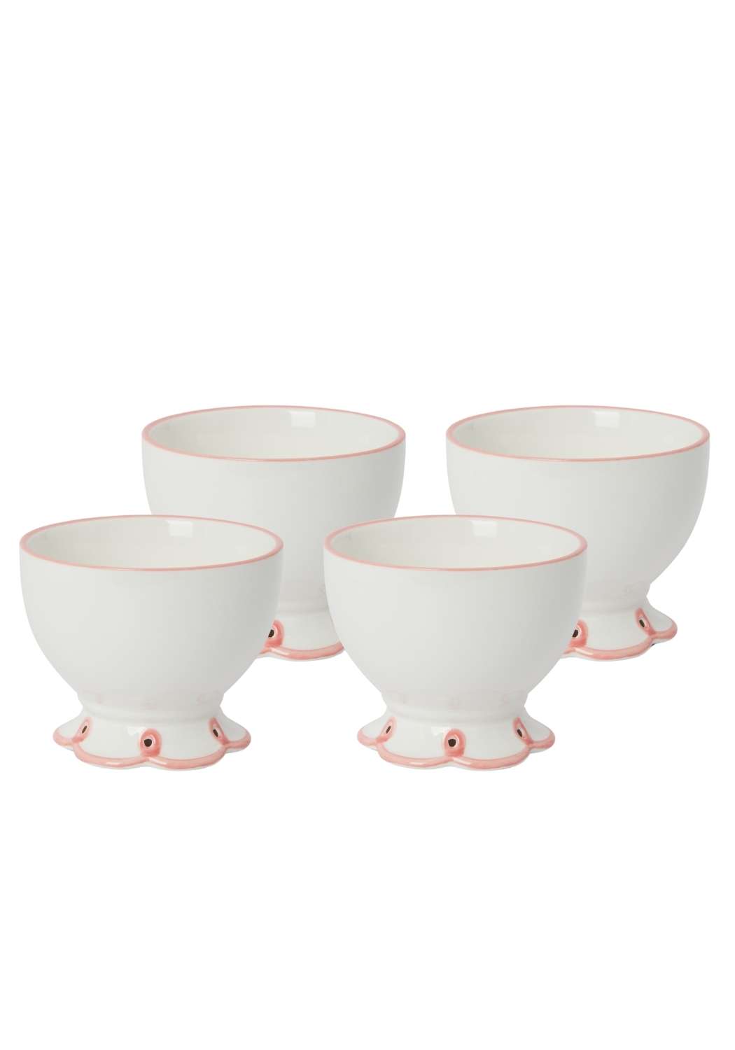 Set of four white ceramic bowls with pink bases on a white background