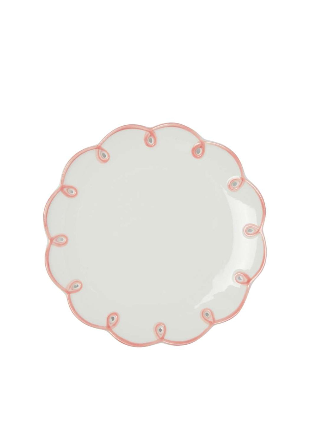White plate with pink scalloped decorative edge on a white background