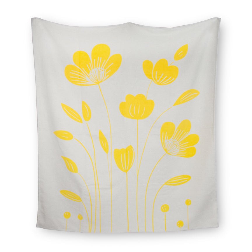 White blanket with yellow floral patterns on a white background