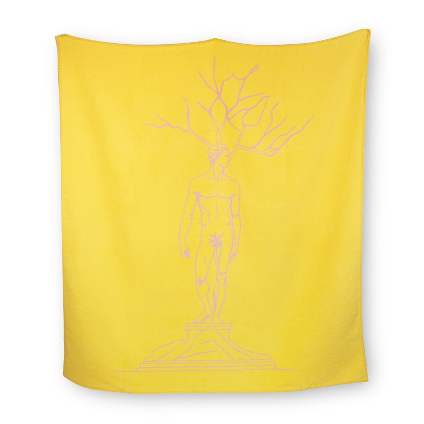 Yellow blanket with a white outline of a statue design on a white background