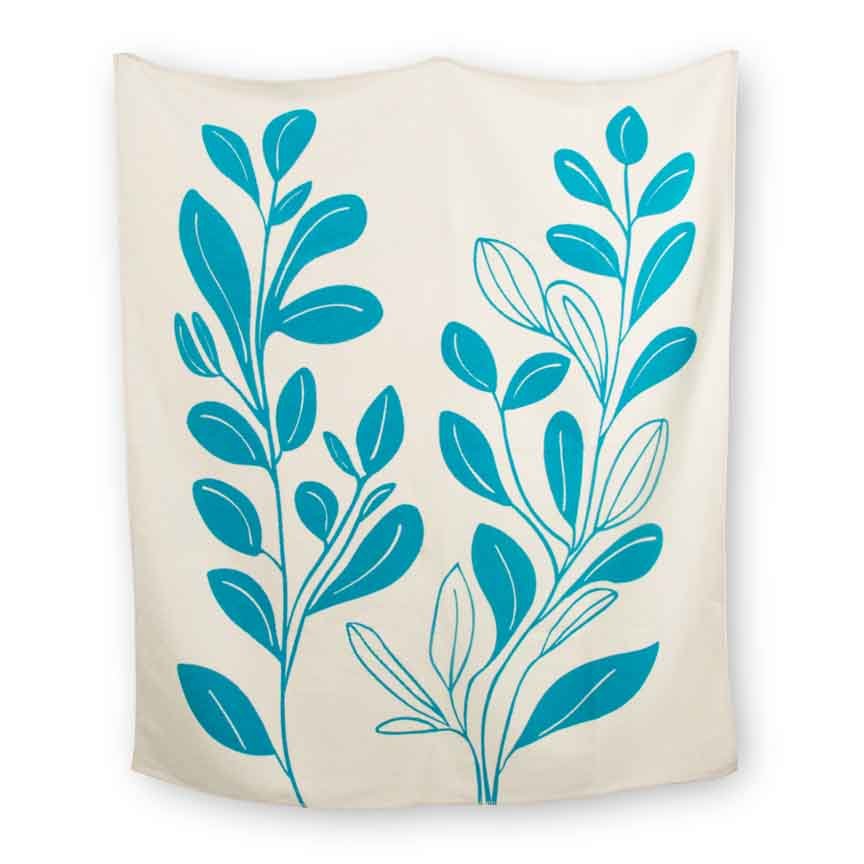 Beige blanket with blue leaf patterns on a white background