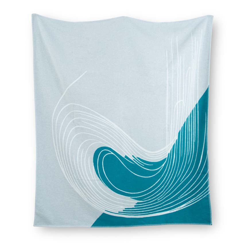 Teal and white patterned blanket on a white background