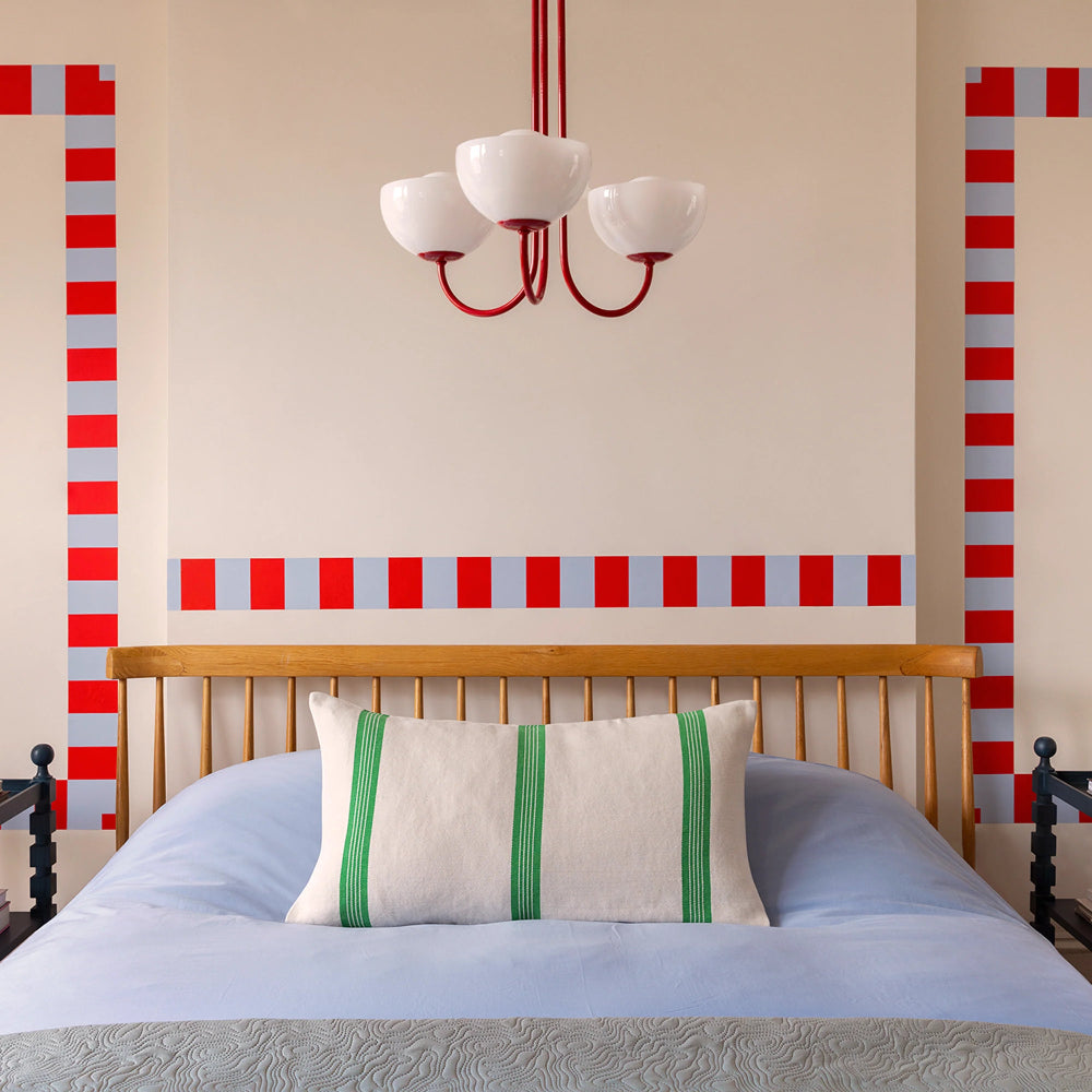 Bedroom with a wooden headboard, blue bedding, and decorative pillows.