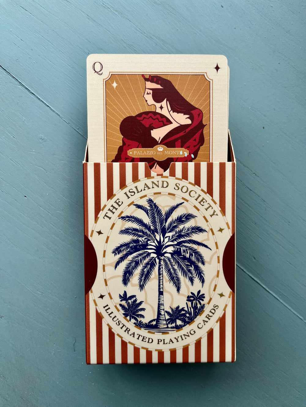 Decorative red playing cards from The Island Society, a gift for traditional card game enthusiasts.