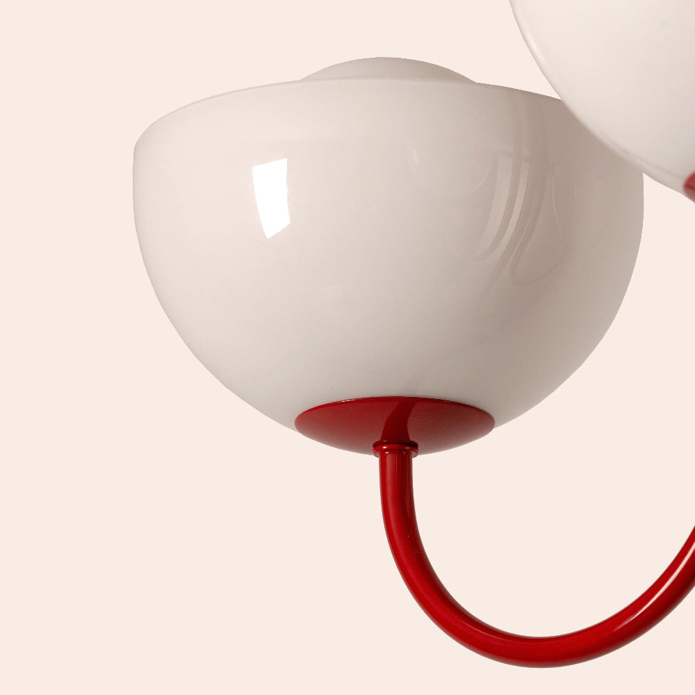 Close-up of glossy red dome shade and opal glass diffuser