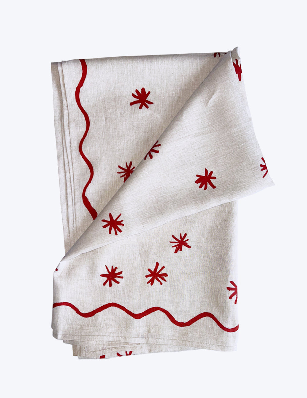 Linen tablecloth with red star patterns on a white background