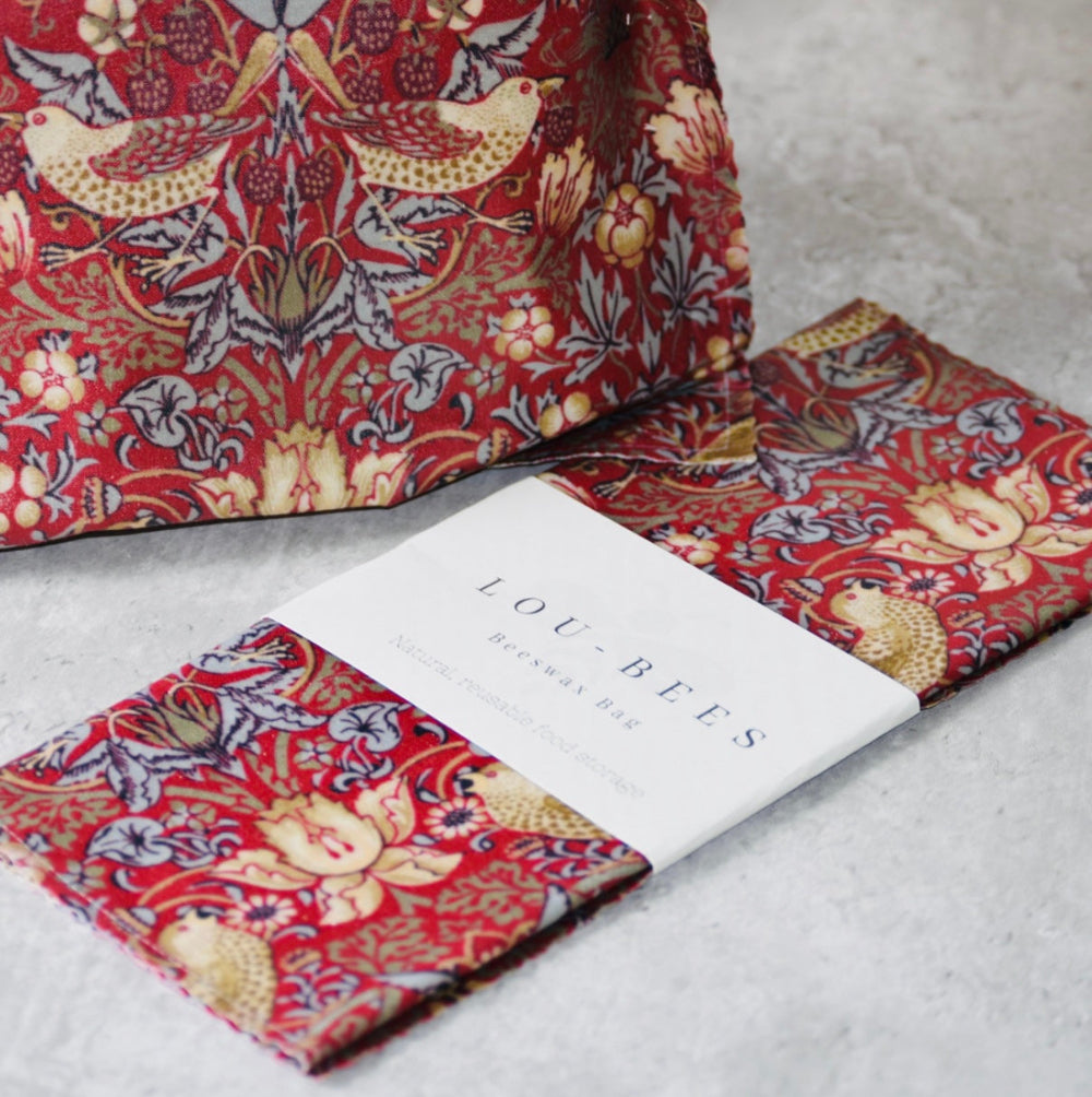 Red floral patterned beeswax wraps bag on a light grey surface with 'LOU BEES' branding.