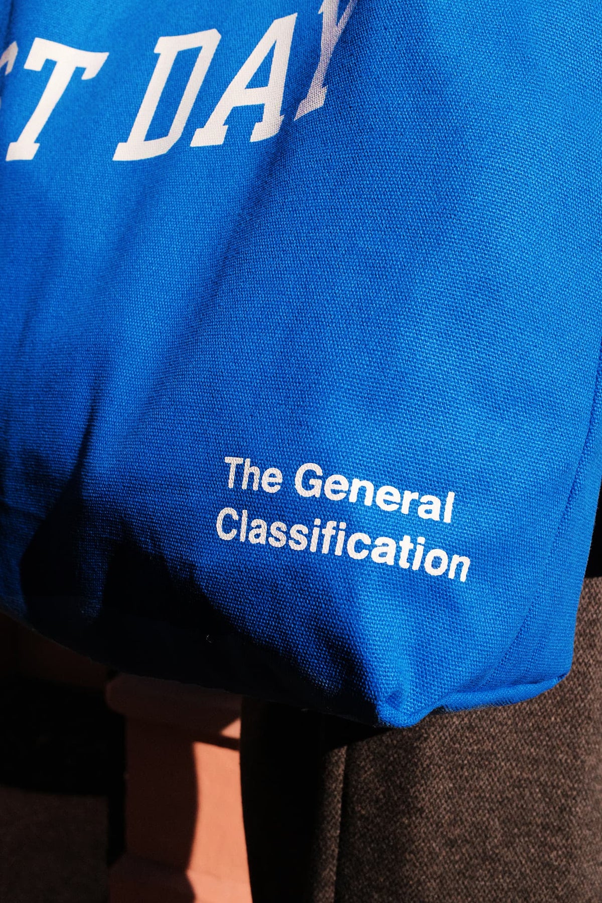 Blue fabric with text 'REST DAY' and 'The General Classification' on a dark background