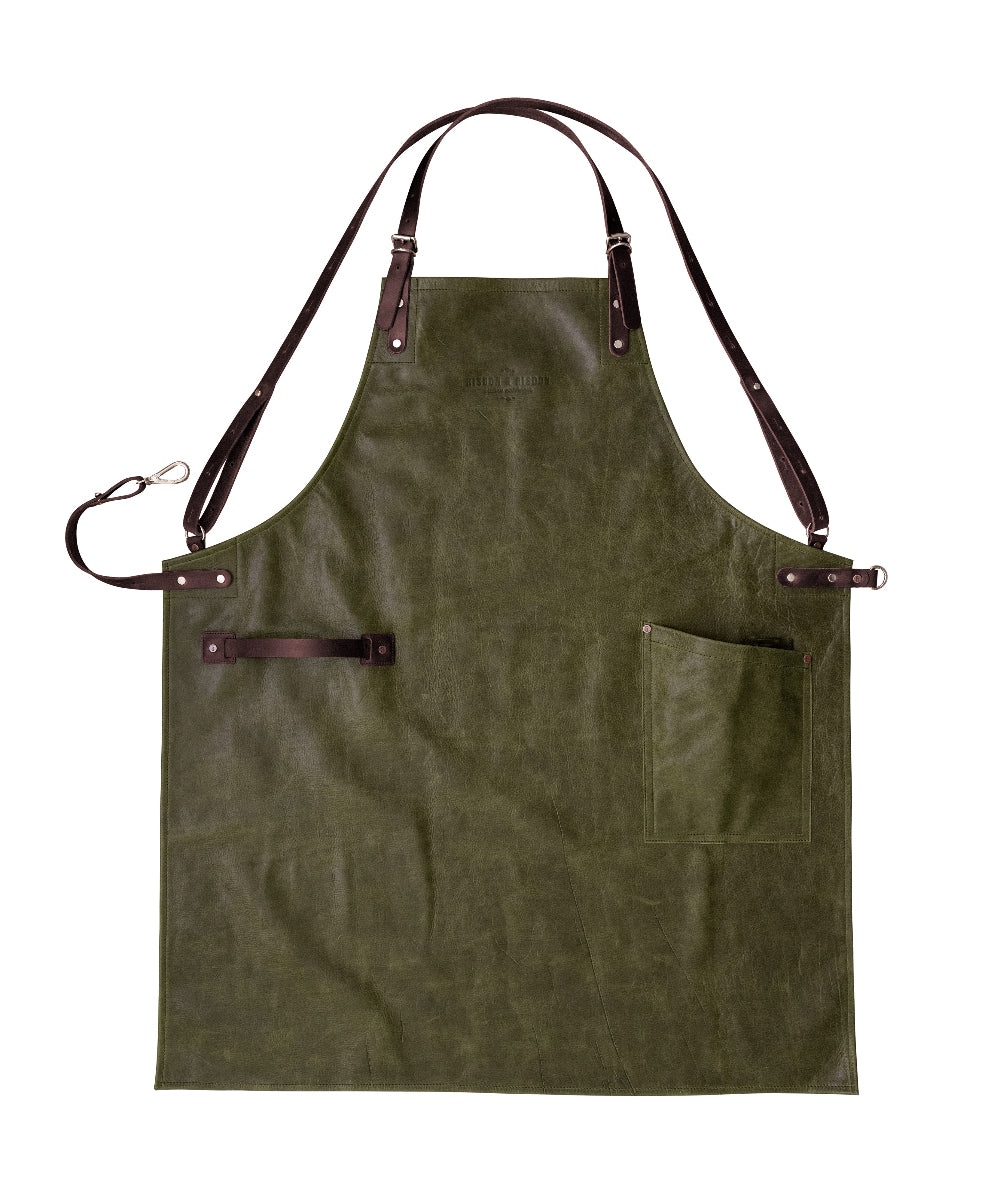 Green apron with brown leather straps on a white background