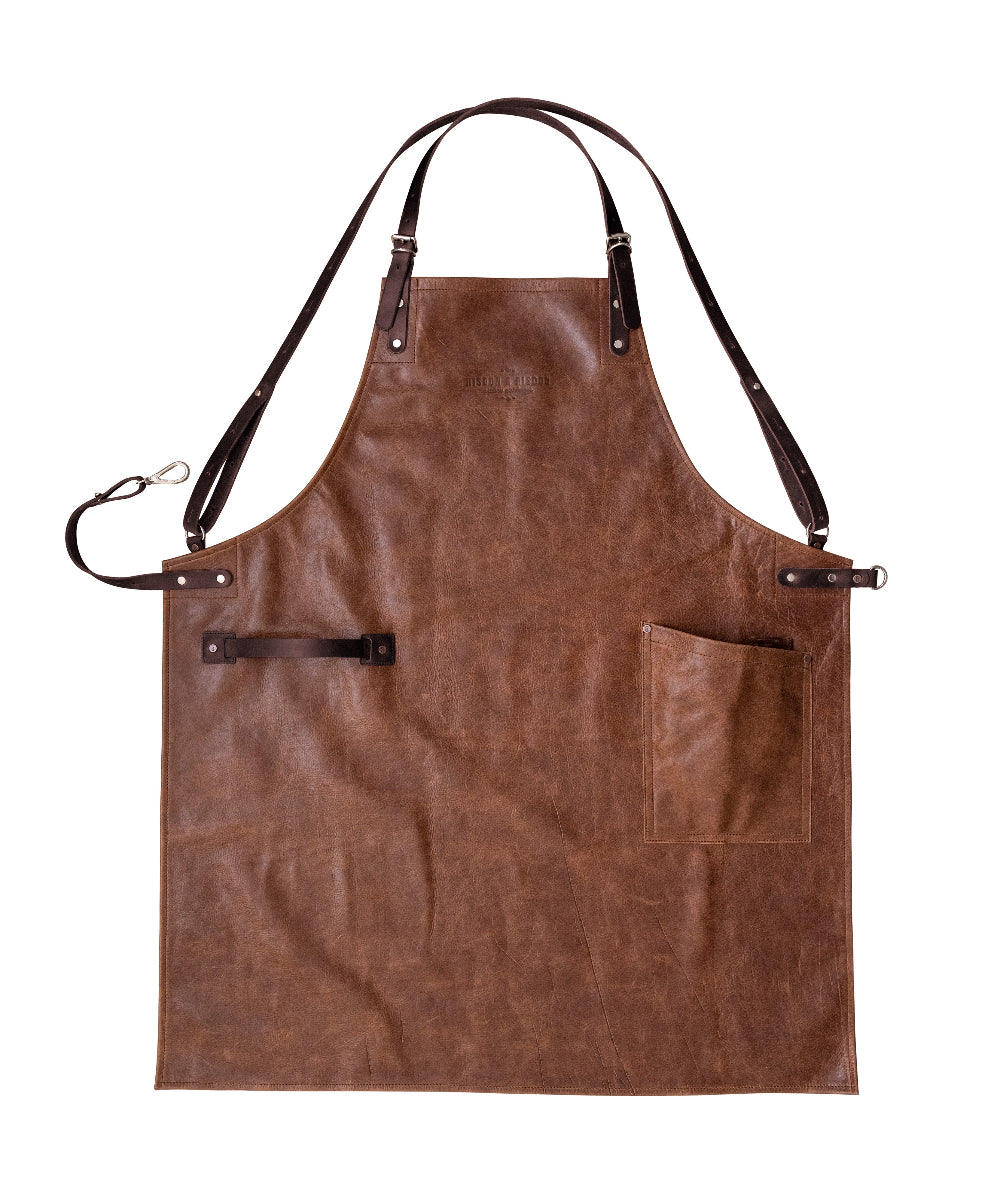 Brown leather apron with black straps on a white background