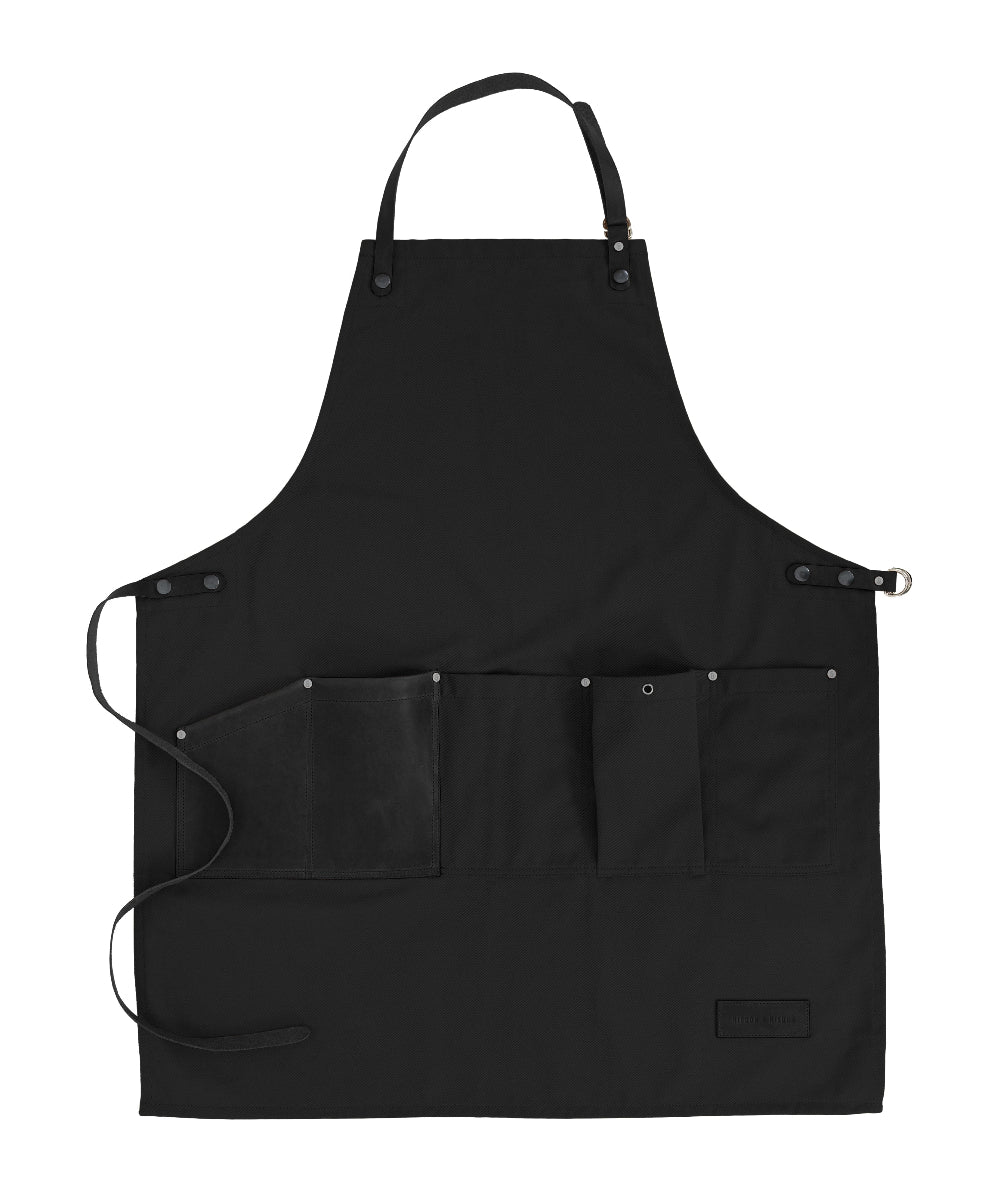 Black apron with multiple pockets on a white background