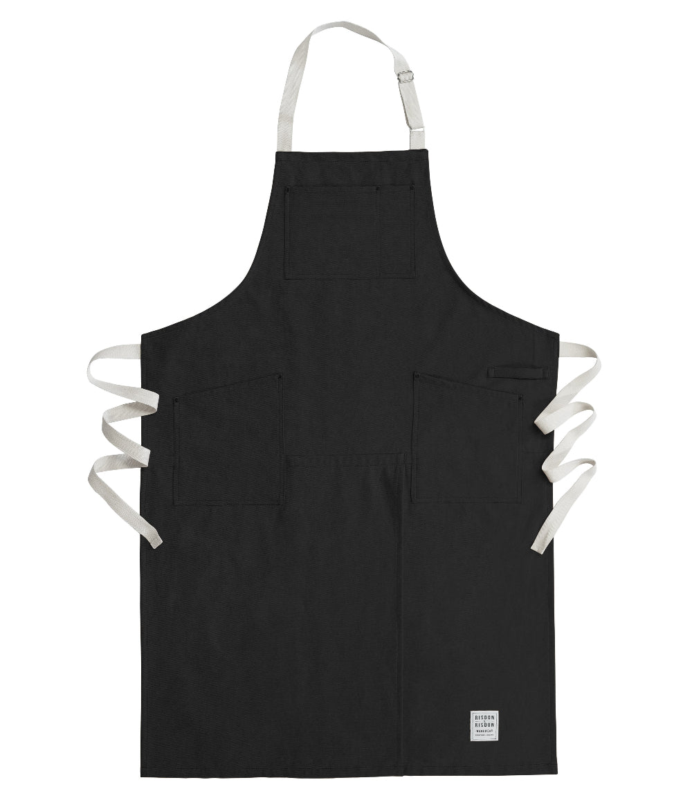 Black potters apron with white straps on a white background