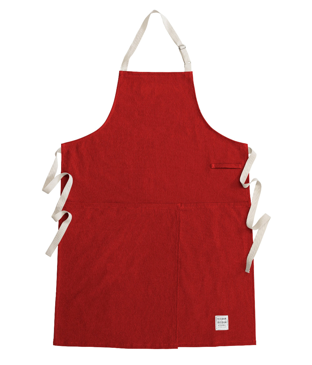 Red potters apron with white straps on a white background