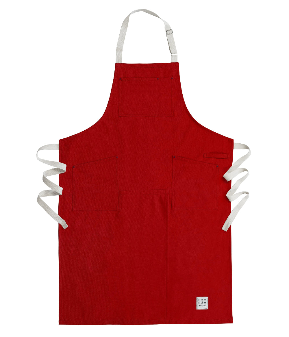 Red potters apron with white straps on a white background