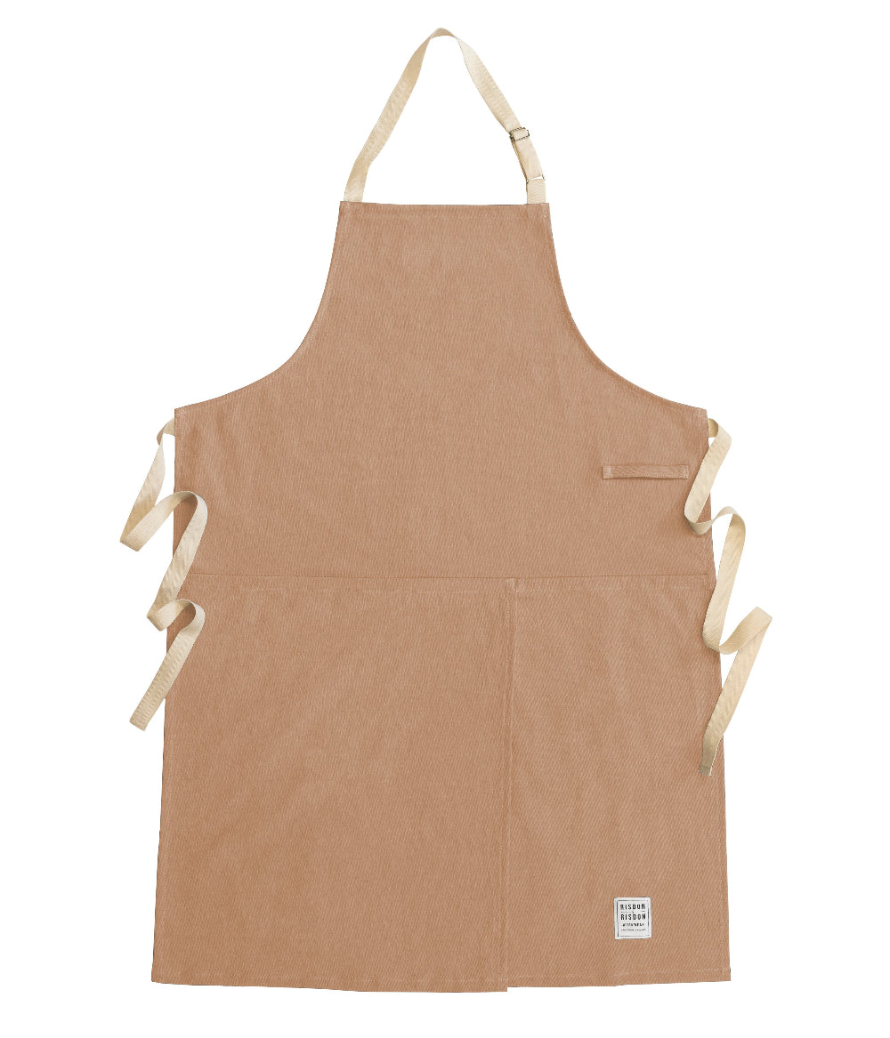 Brown potters apron with white straps on a white background