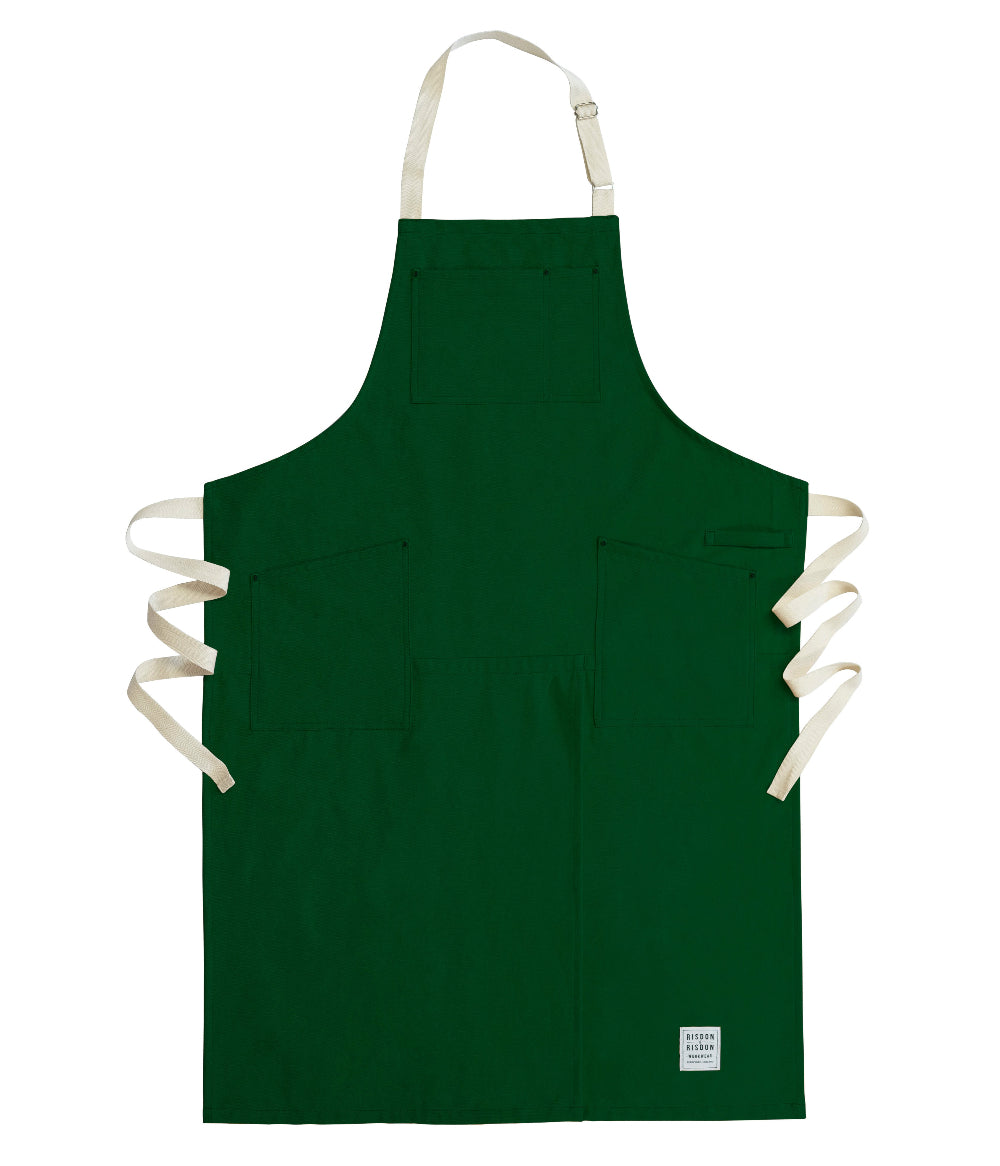 Green potters apron with white straps on a white background