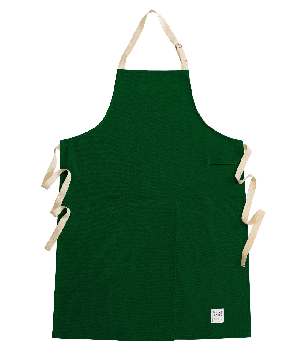 Green potters apron with beige straps on a white background