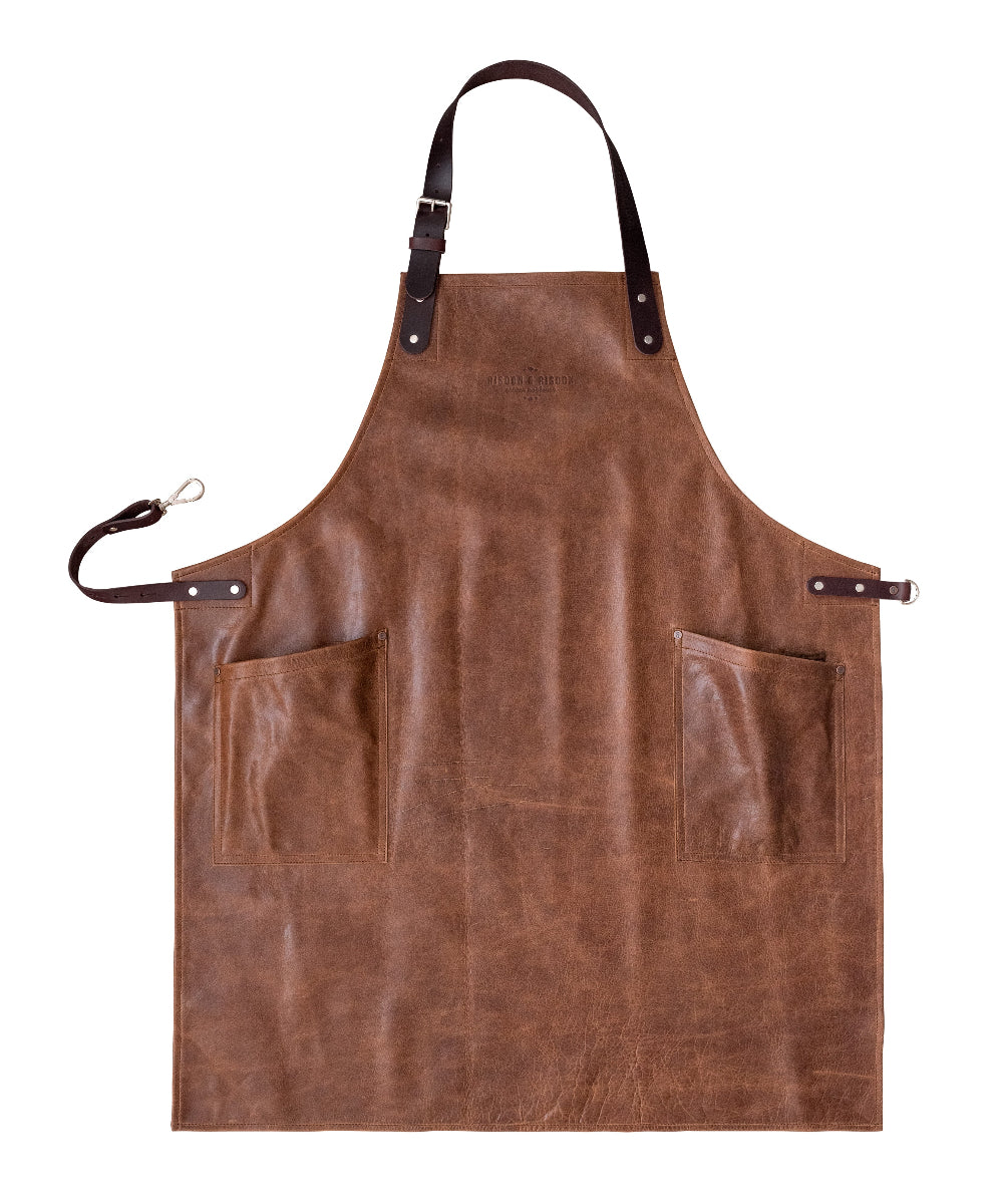 Brown leather apron with pockets and a strap on a white background