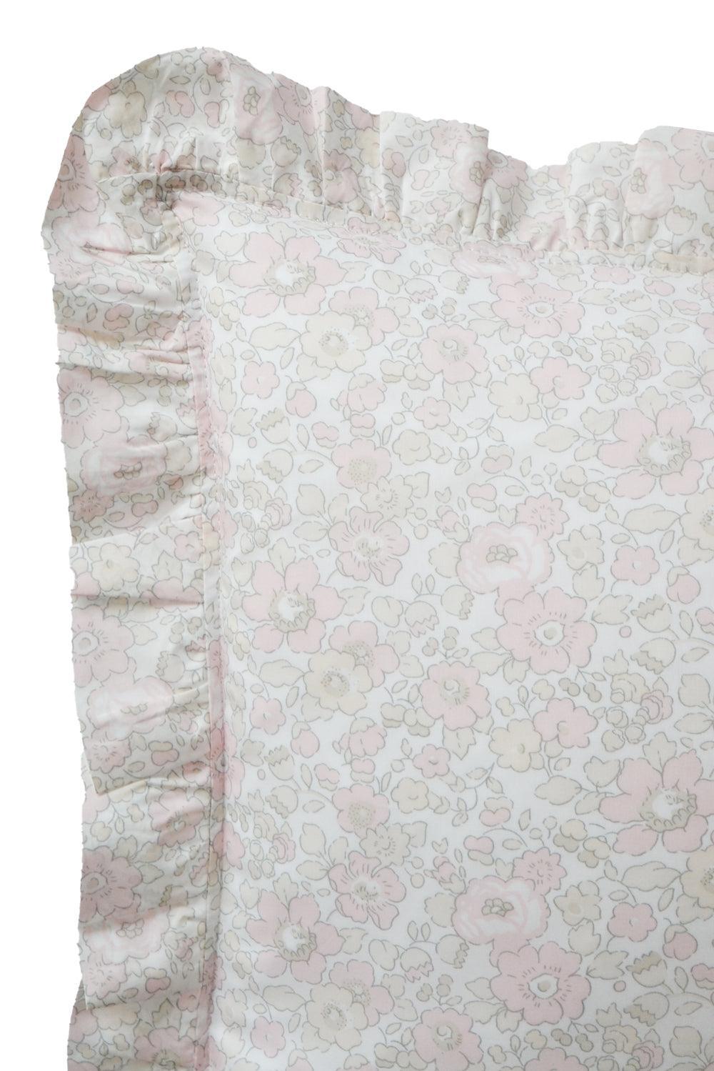 Floral patterned fabric with ruffled edge on a white background
