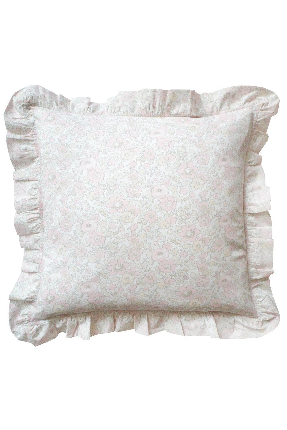White pillow with ruffled edges on a white background