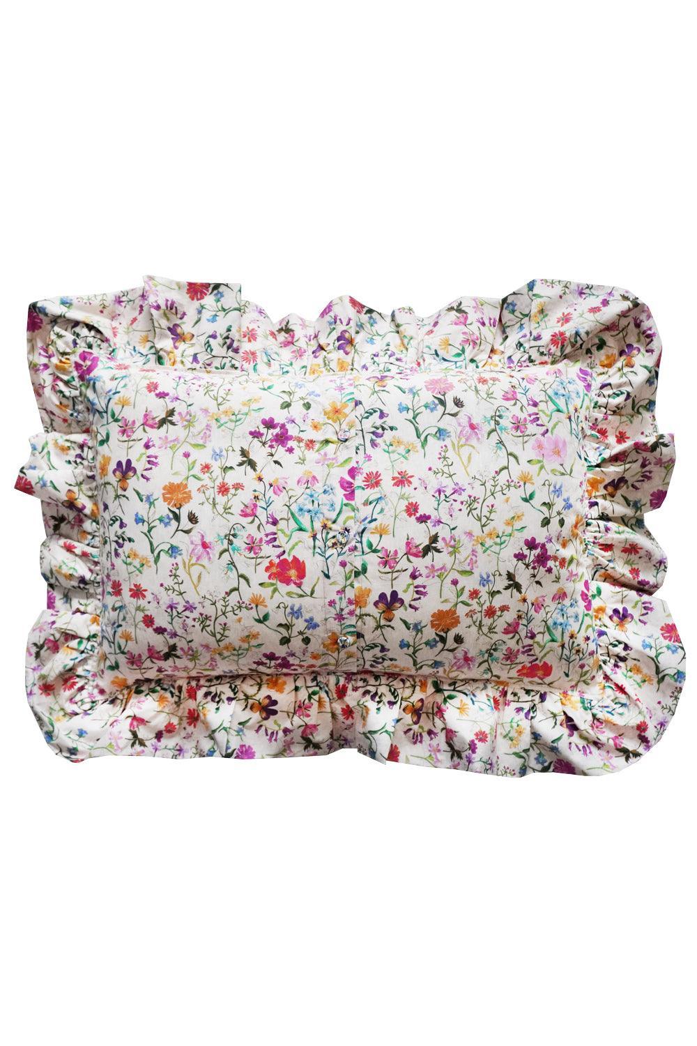 Floral pillow with ruffled edges on a white background