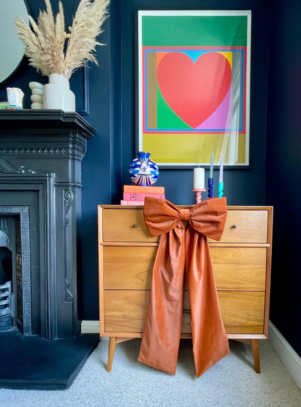 Rust velvet bow styled on a chest of drawers for autumn decorating