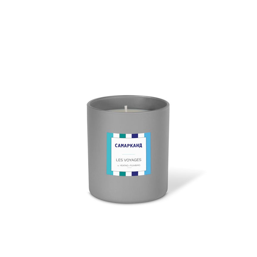 Grey candle with a label on a white background