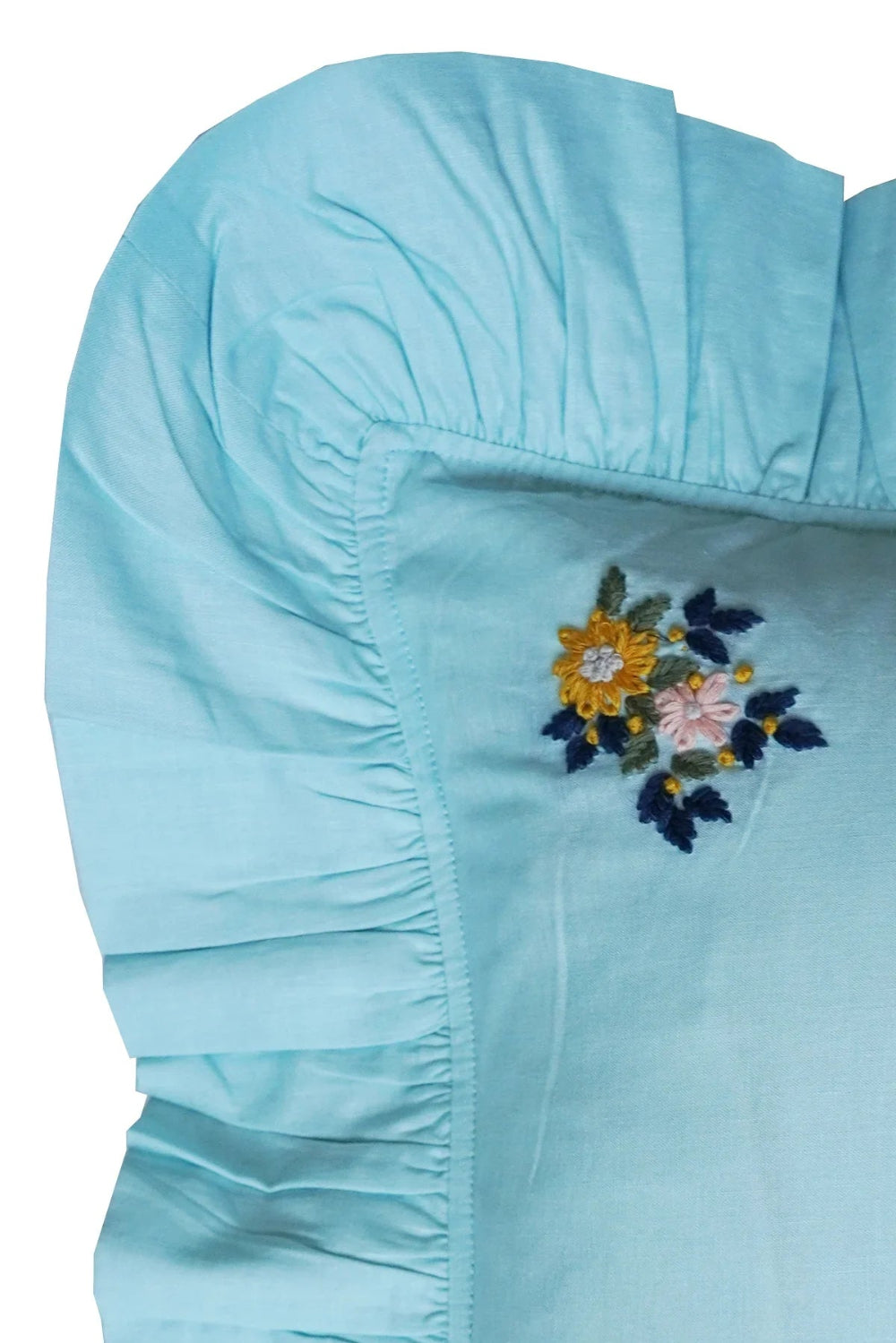 Light blue fabric with floral embroidery cushion oblong shape corner view on a white background