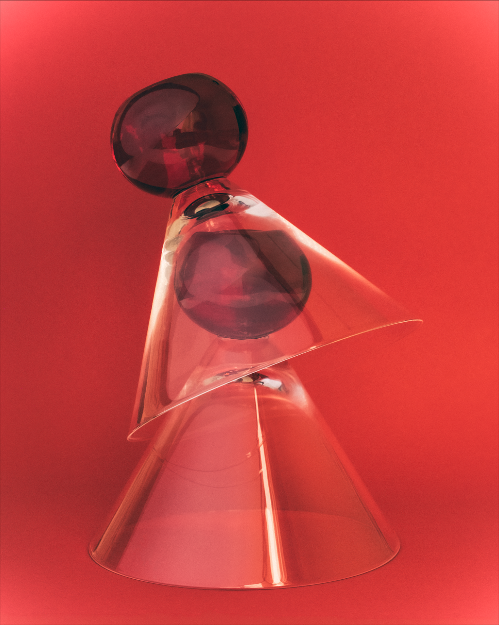 Clear cocktail glasses with a red background
