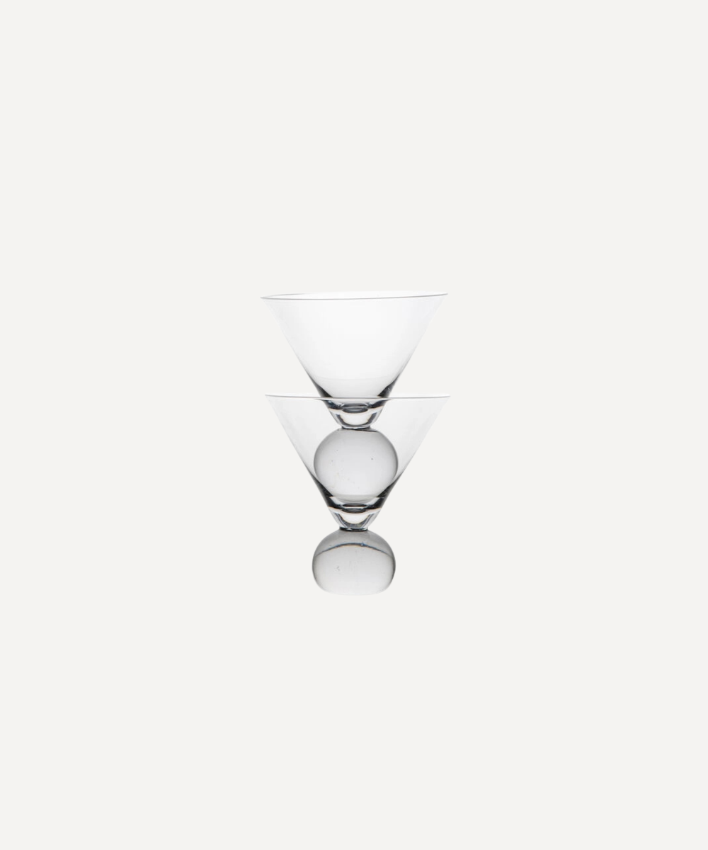 Clear martini glass with bobble stems on a white background