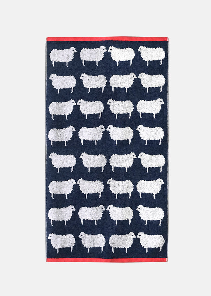 Navy towel with white sheep pattern on a white background