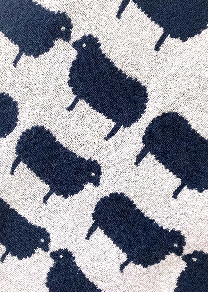 Pattern of dark blue sheep silhouettes on a light grey background