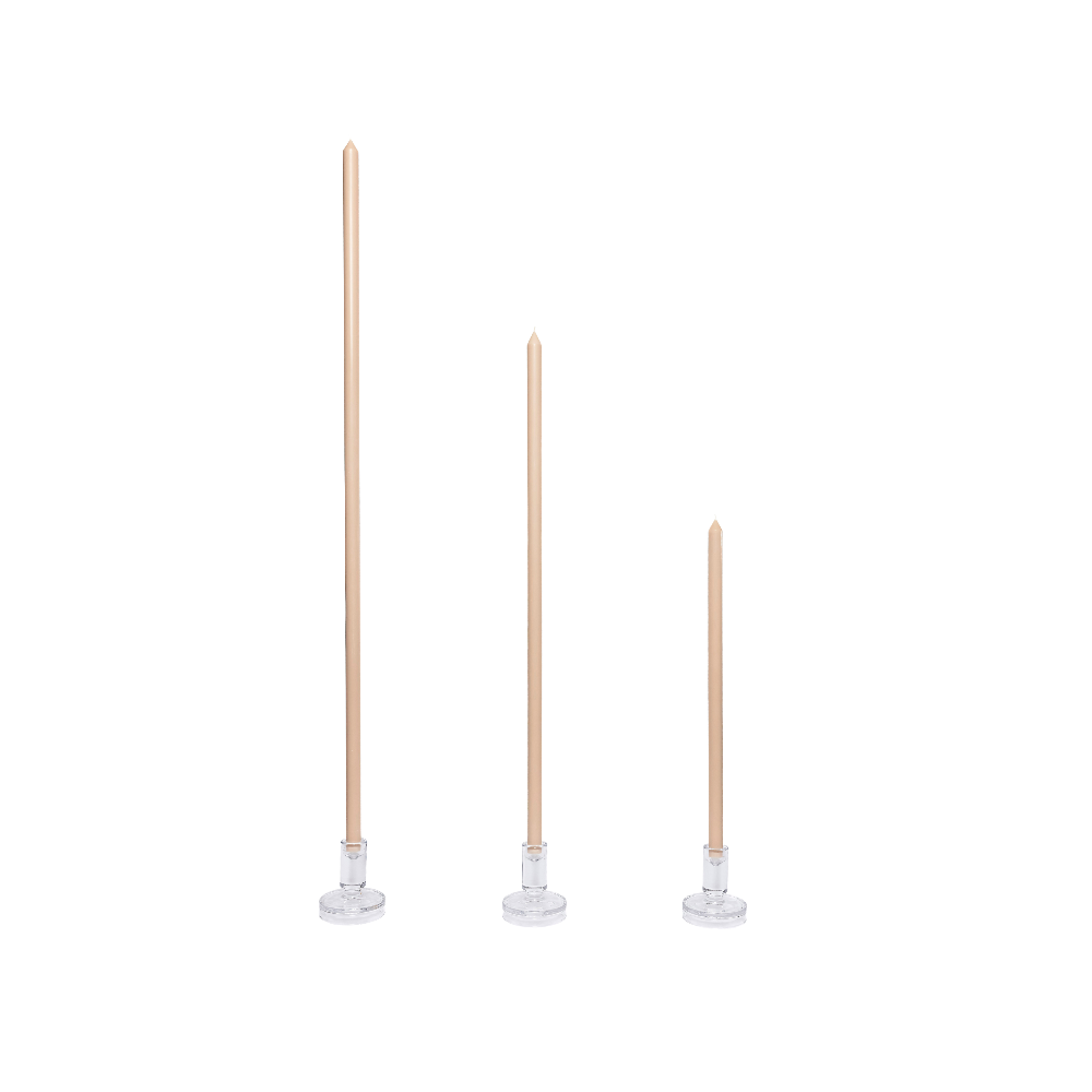 Three tall, thin candles with wooden holders on a white background