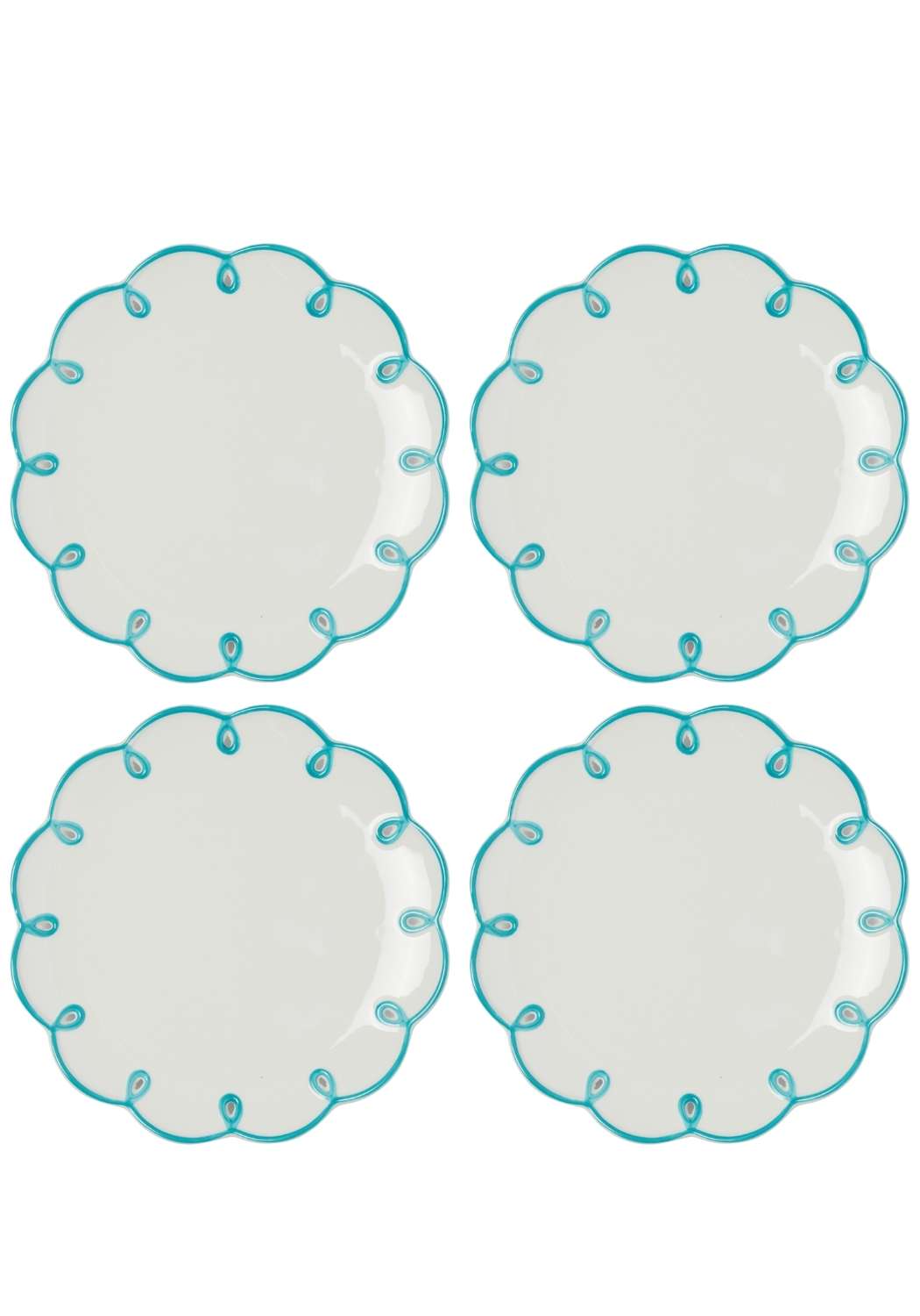 Four white plates with turquoise decorative scalloped edges on a white background
