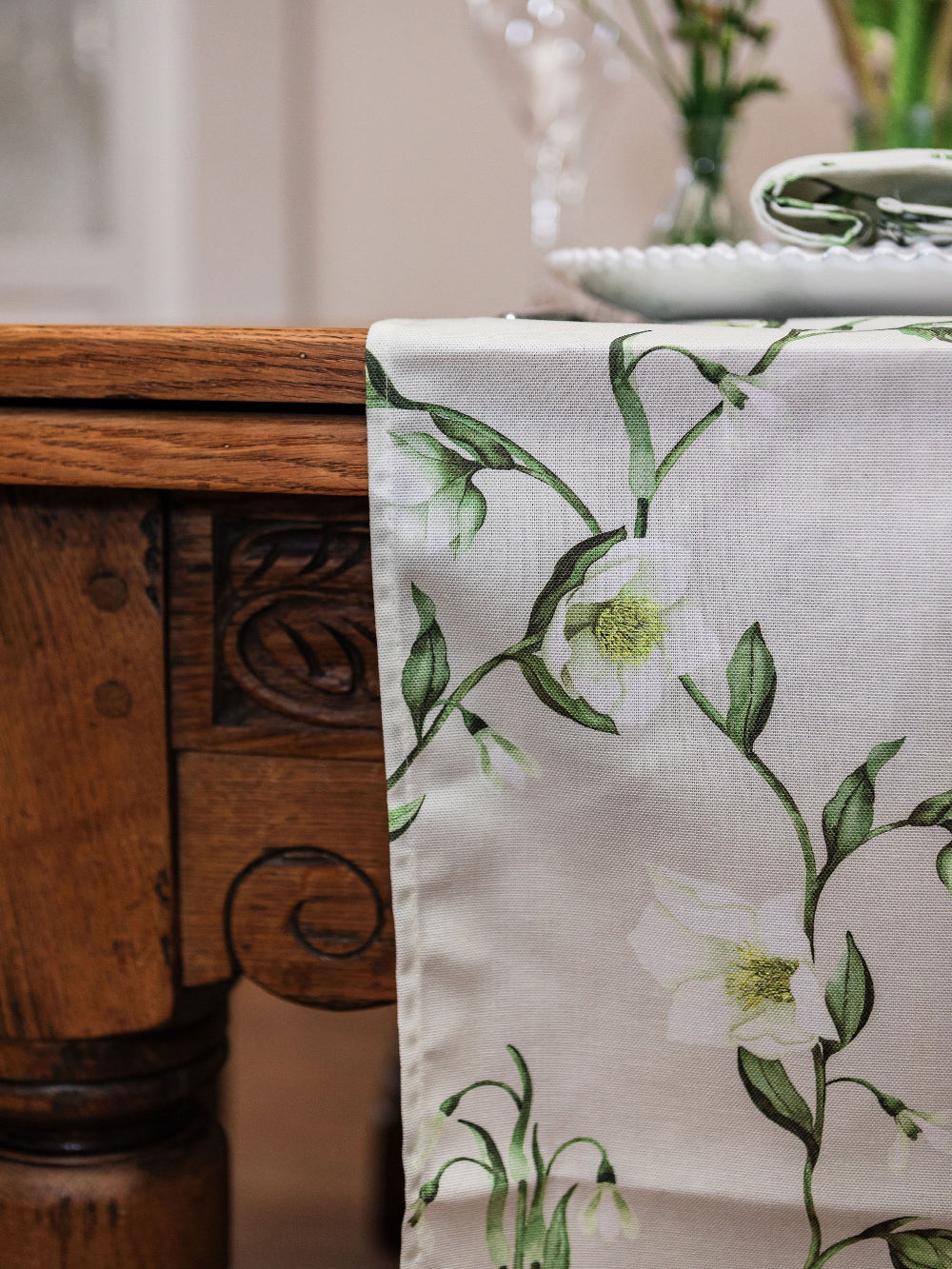 Floral-patterned table runner on a wooden table