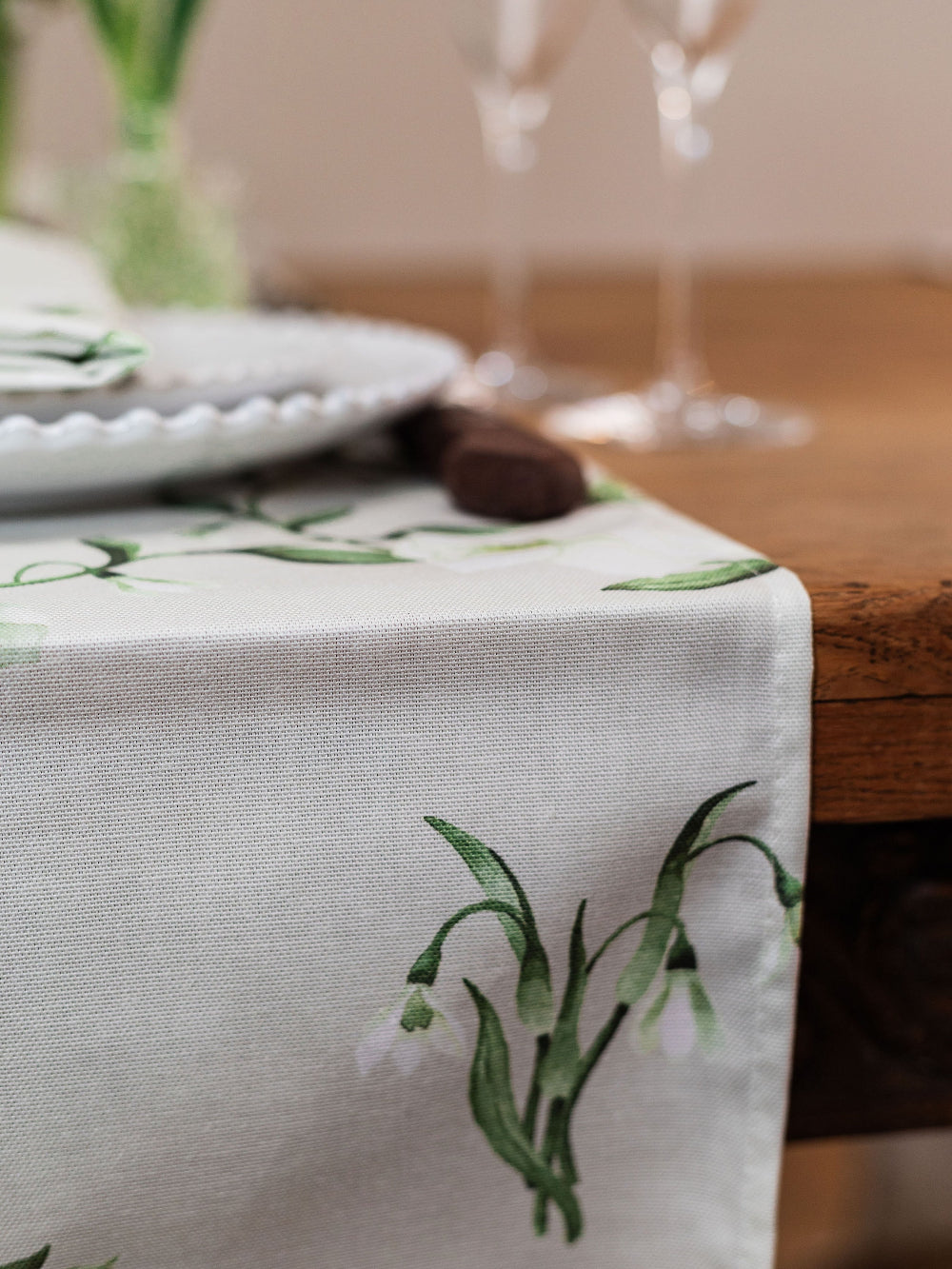 Table runner with snowdrop floral design on a wooden table