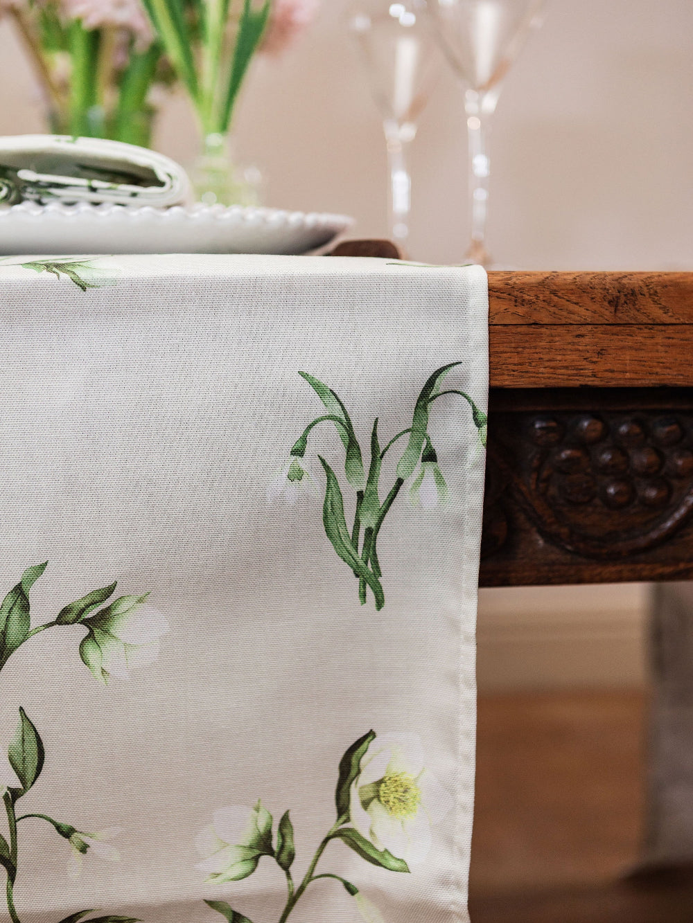 Floral-patterned table runner on a wooden table