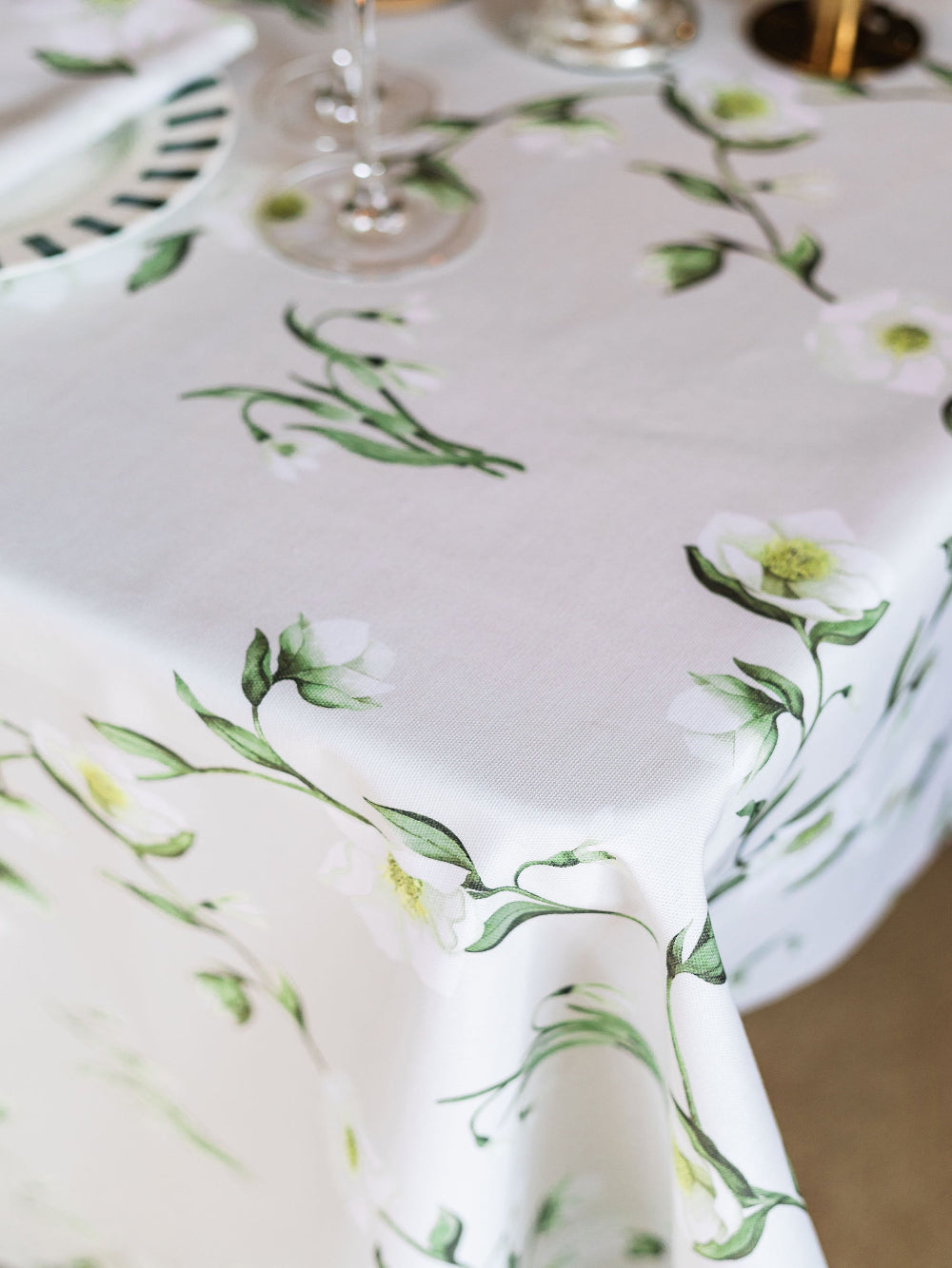 Tablecloth with green floral pattern on a table setting