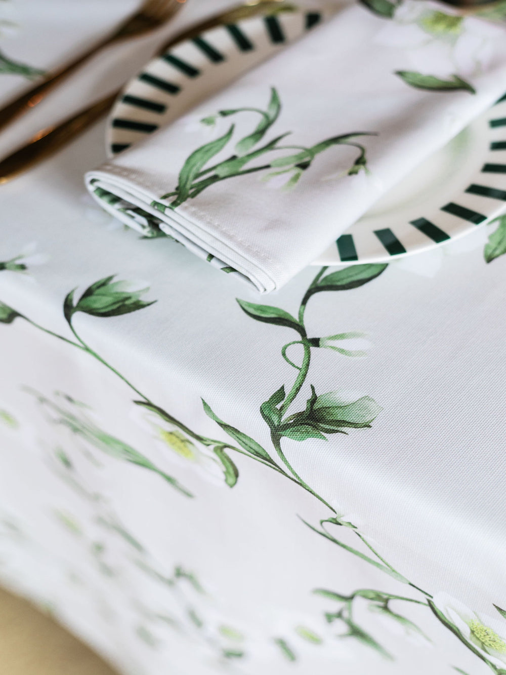 Floral-patterned fabric with green leaves on a white background