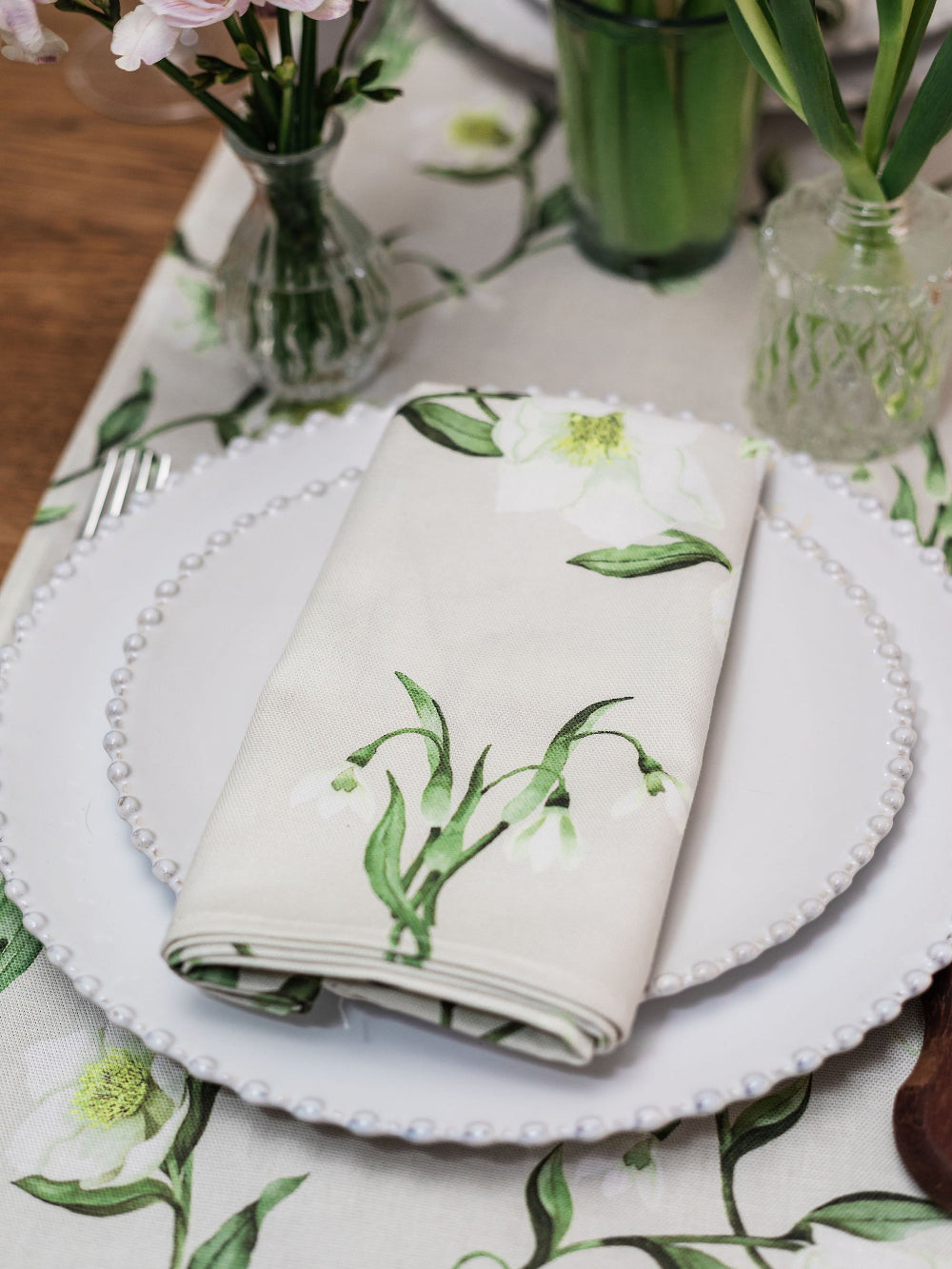 Table setting with floral-patterned napkin and tablecloth