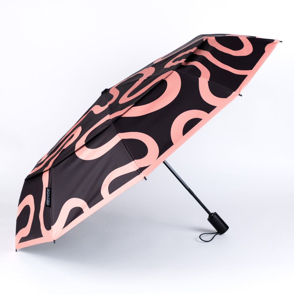 Black umbrella with pink wavy pattern on a white background